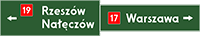 znak E-2b Drogowskaz tablicowy umieszczany nad jezdnią.